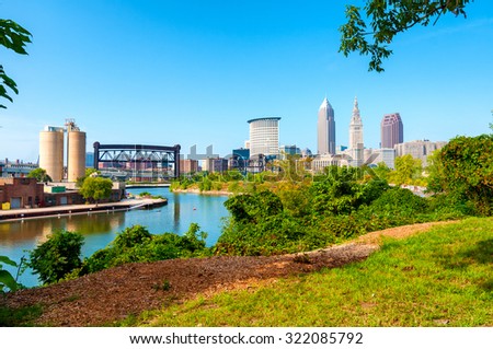 View of downtown Cleveland, Ohio, and the Cuyahoga River from a park on the west bank of the river Royalty-Free Stock Photo #322085792