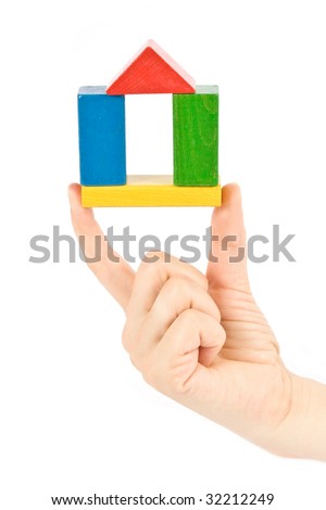 hand which holds a colorful small house