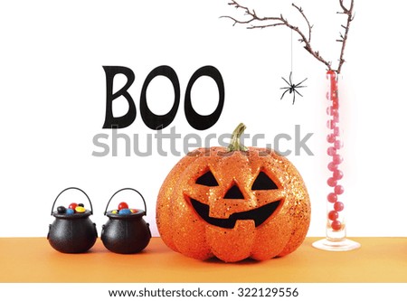 Happy Halloween modern orange and white party table with decorations and Boo sign.