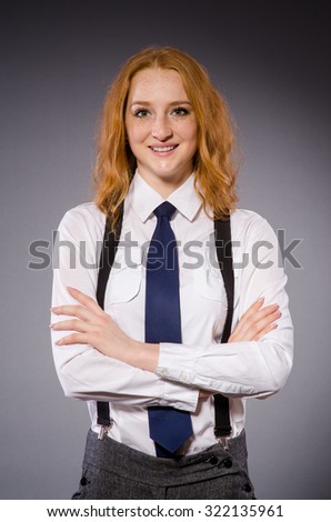 Red hair girl in classic style against gray