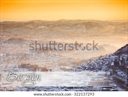 postcard with view of winter city with fog  from the mountain top