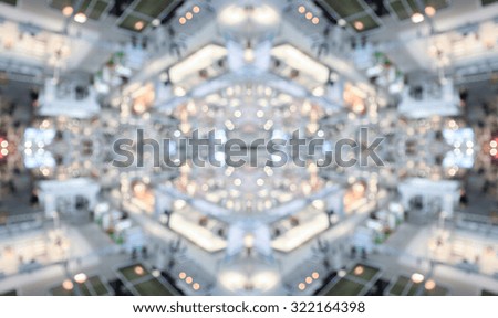 Symmetrical background with lights and people silhouettes. Intentionally blurred post production.