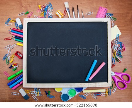 school supplies and blackboard with copy space on the table