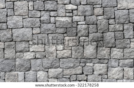 Old gray stone wall, seamless background photo texture