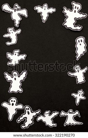 a vertical overhead view of a halloween frame made by ghosts