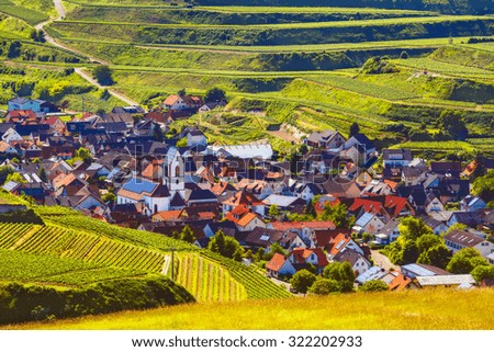 Picturesque summer vineyard landscape with with a historic town in Germany, Black Forest, Kaiserstuhl. Travel and winery background. Filtered, diffused.