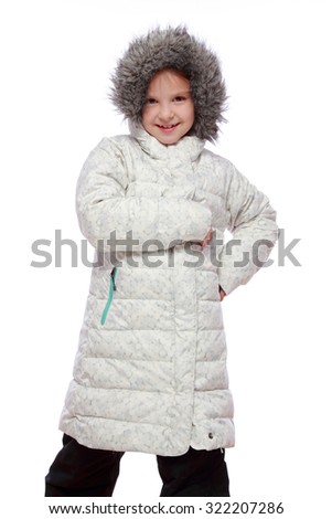 Portrait of a pretty joyful young girl in a warm white coat isolated on white