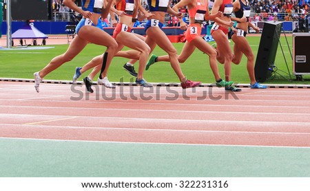 Women run on the stadium at sports competition 