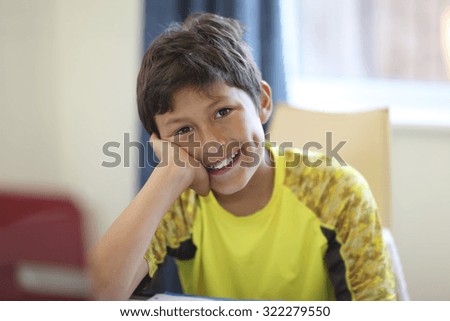 Young boy doing his homework on a computer - shallow depth of field