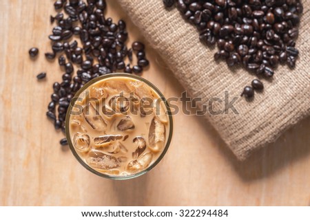Ice coffee with fresh coffee on a wooden background Royalty-Free Stock Photo #322294484