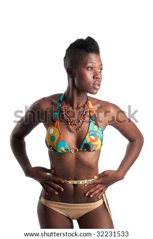 Slim african american girl in bikini with tape measure around her perfect waist