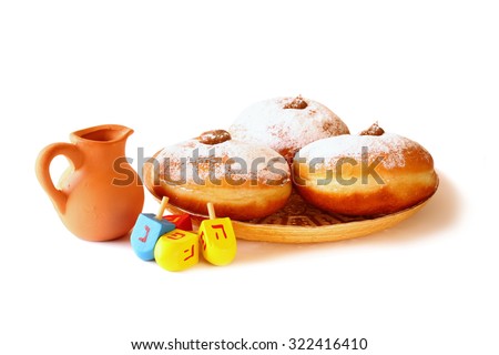 image of jewish holiday Hanukkah with donuts, traditional chocolate coins and wooden dreidels (spinning top). isolated on white 