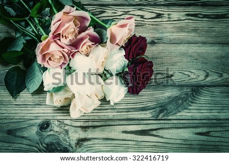 Vintage background with roses flower on rustic table