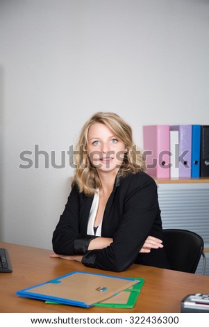 Young smiling business woman working with computer