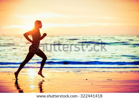 Woman running on the beach at sunset - male version in portfolio Royalty-Free Stock Photo #322441418