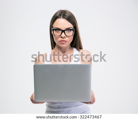 Portrait of a cute female student standing with laptop isolated on a white background