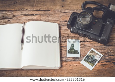 Vintage camera and book on wooden background,Vintage color tone