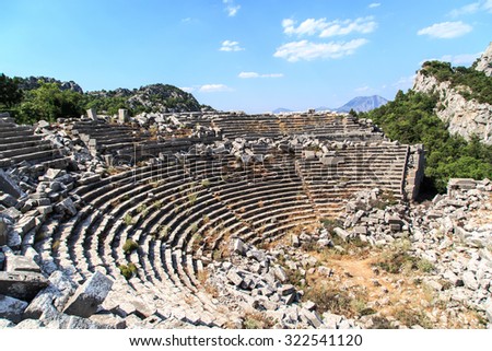 Top view of amphitheater of Termessos Antique City in Antalya, on cloudy blue sky background.