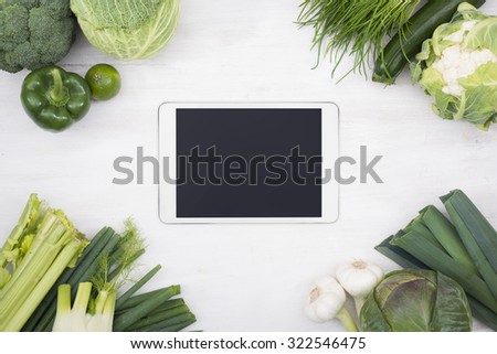 Tablet pc surrounded by vegetables