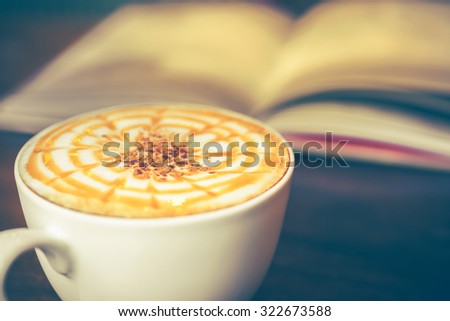 vintage picture of cappuccino coffee with book, vintage tone 