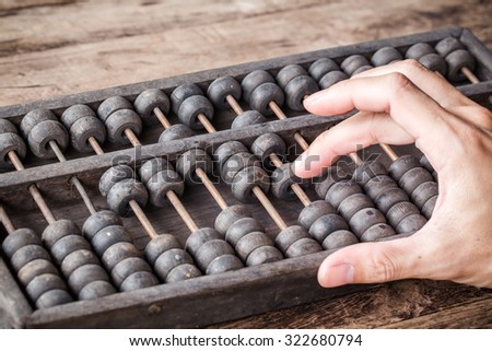 Man's hands accounting with old abacus and hold electronic calculator. picture financial concept