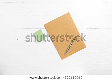 brown paper with sticky note on white table view from above