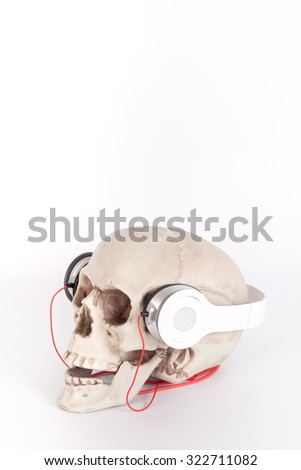 Human Skull listen to music by headset/headphone isolated on white Background