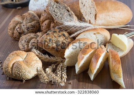 Rural rolls and bread with butter and spikes of wheat Royalty-Free Stock Photo #322838060