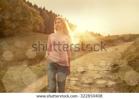 Happiness woman stay outdoor under sunlight of sunset
