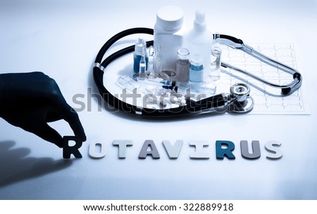 Diagnosis - Rotavirus. Medical concept with pills, injection, stethoscope, cardiogram and a syringe Royalty-Free Stock Photo #322889918