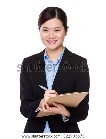 Businesswoman write on clipboard