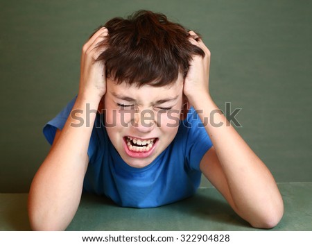 preteen handsome boy scratch his head isolated on blue