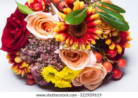 Autumn wedding bouquet close up with flowers and berries. Picture taken in the studio.