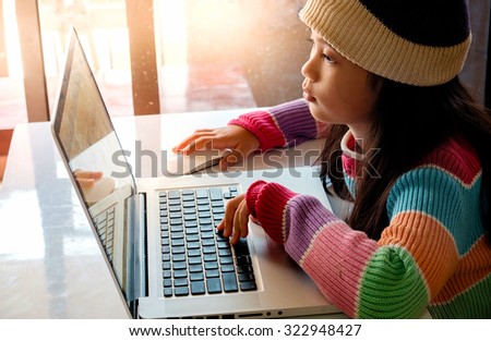 Asian Girl using a laptop.
