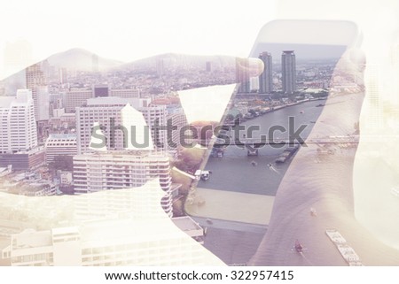 Double exposure image of people with smart phone and cityscape background,Business technology concept.