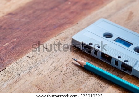 image of empty  paper cassette tape over wooden table. vintage effect