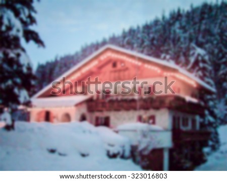 View of a chalet, mountains landscape background, intentionally blurred post production.