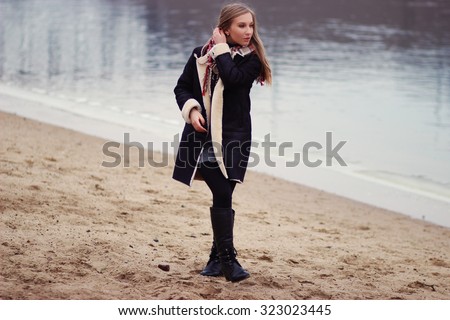 Fashion woman in fur coat, lady portrait. Lady on the river bank