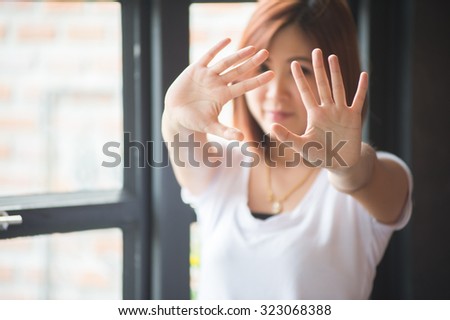 Asian women showing stop hand gesture,  focus hand