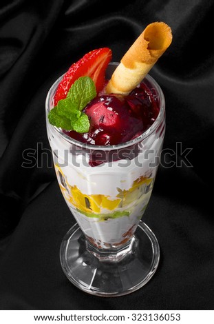  Dessert with ice-cream, topping, cherries, strawberries and waffle