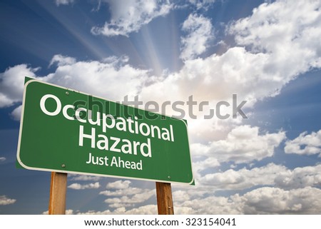 Occupational Hazard Green Road Sign With Dramatic Clouds and Sky.
