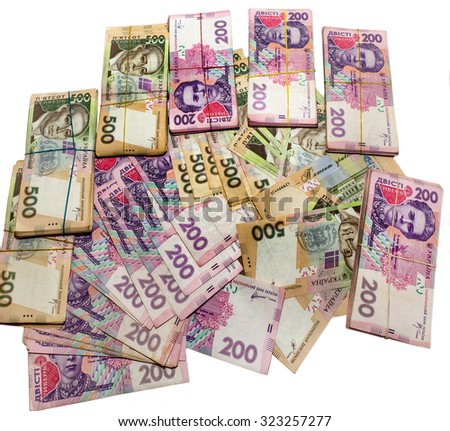 Many Ukrainian money hryvnia. Handcuffs on the money. Corruption in Ukraine. The fight against corruption. Physical evidence of corruption in government and business in the country