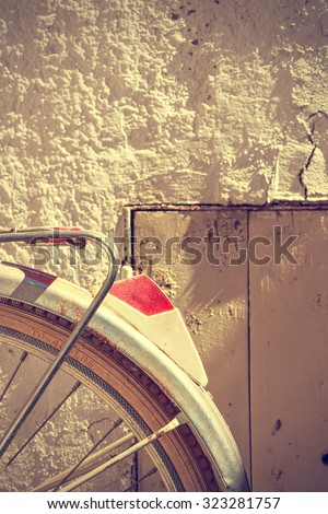 Detail of retro bicycle wheel. It looks part of the rear fender and the brake. Vintage style. Vertical image.