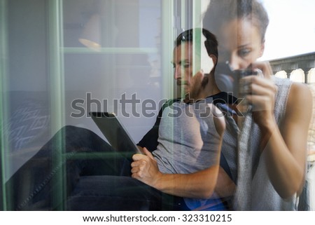 double exposure images. young girl taking pictures of the young man who uses a tablet