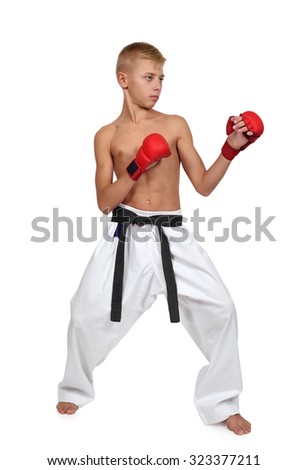 boy in red gloves training karate on white background