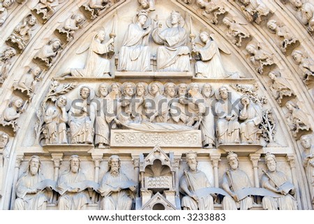 Color DSLR picture of the statues and carvings above the doors of the Cathedral of Notre Dame, Paris, France.  The Catholic Church is a major tourist attraction in the European city. 