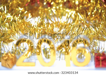 Bokeh of Golden 2016 3d icon with box in the christmas ornaments golden tinsel defocused blur backgrounds