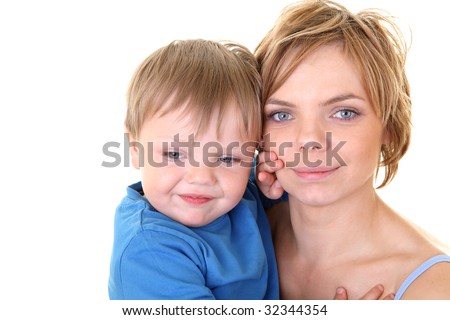 young little son embracing his pretty young mother