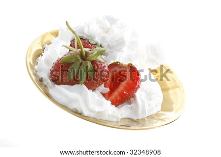 strawberry and cream close-up in a golden plate
