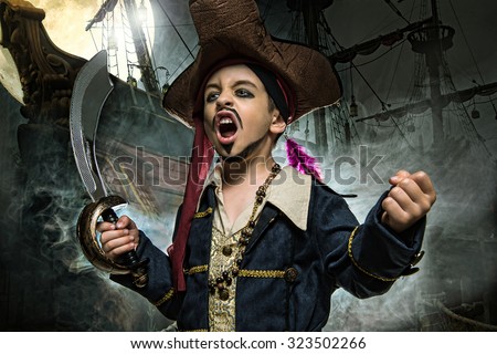 A angry young boy wearing a pirate costume. He stands on the background of the ship 
